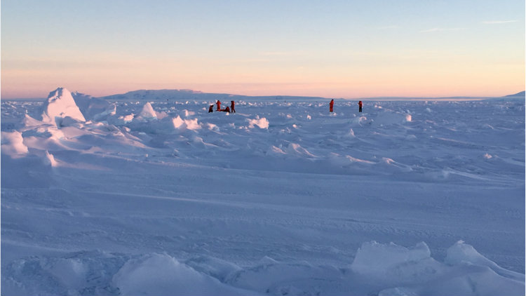 People cut a trail throw snow and ice. 